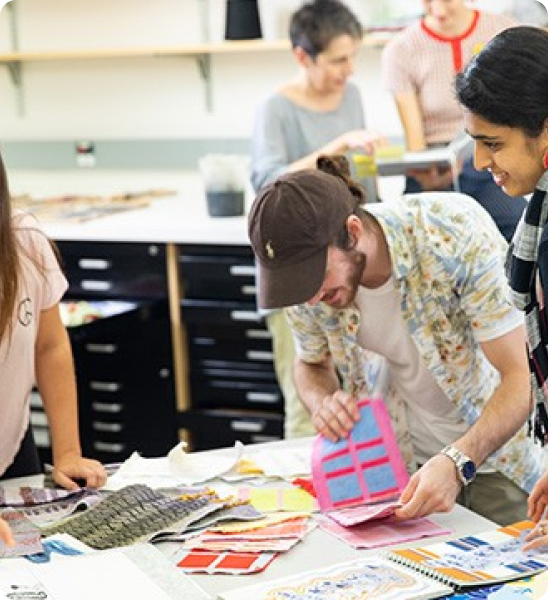 Several students collaborating on a textile project.